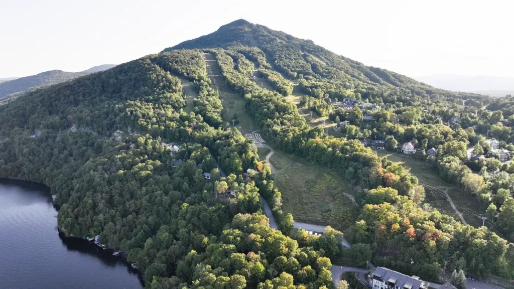 Aerial view of Mount Owl’s Head, its ski runs and homes on Lake Memphremagog
